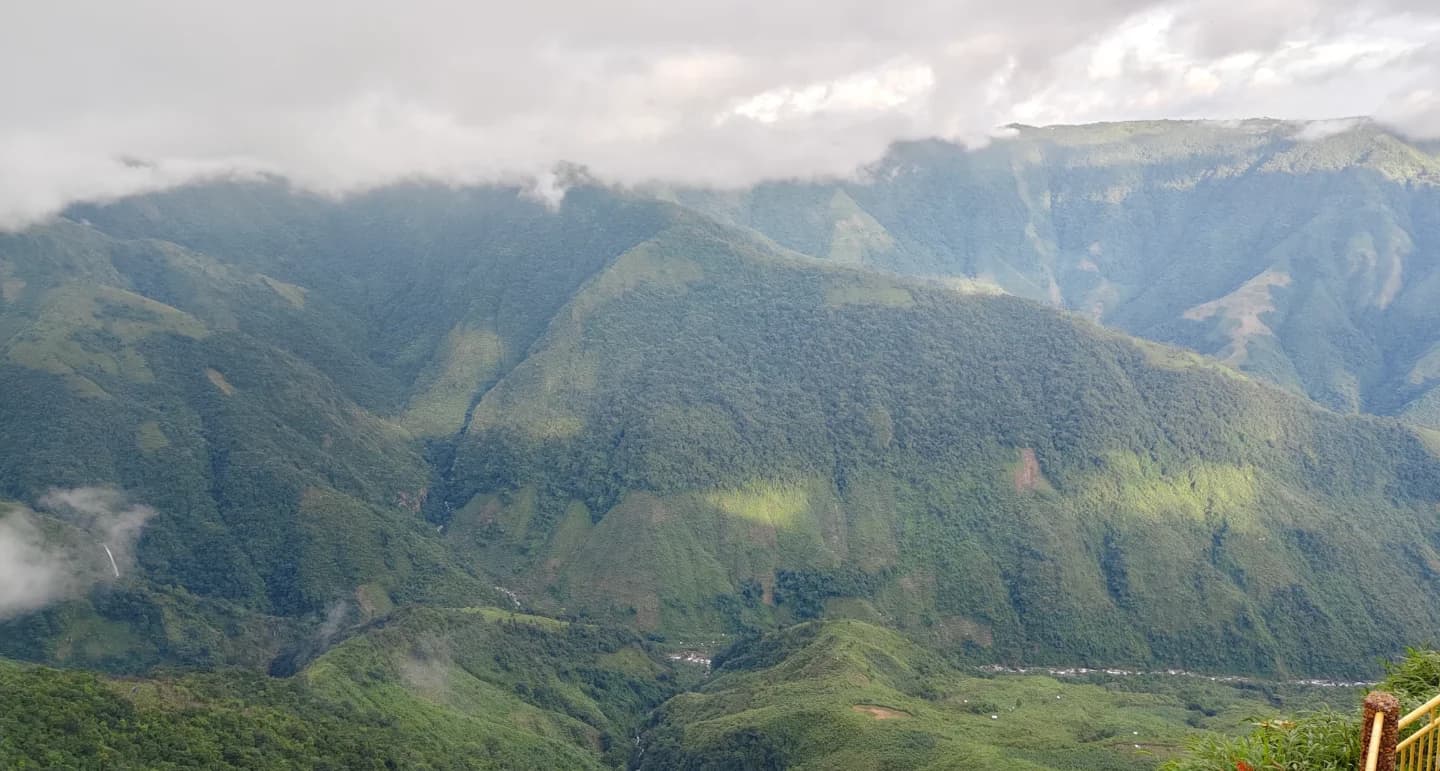 Cloud shadows moving across the steep green hills of the canyon