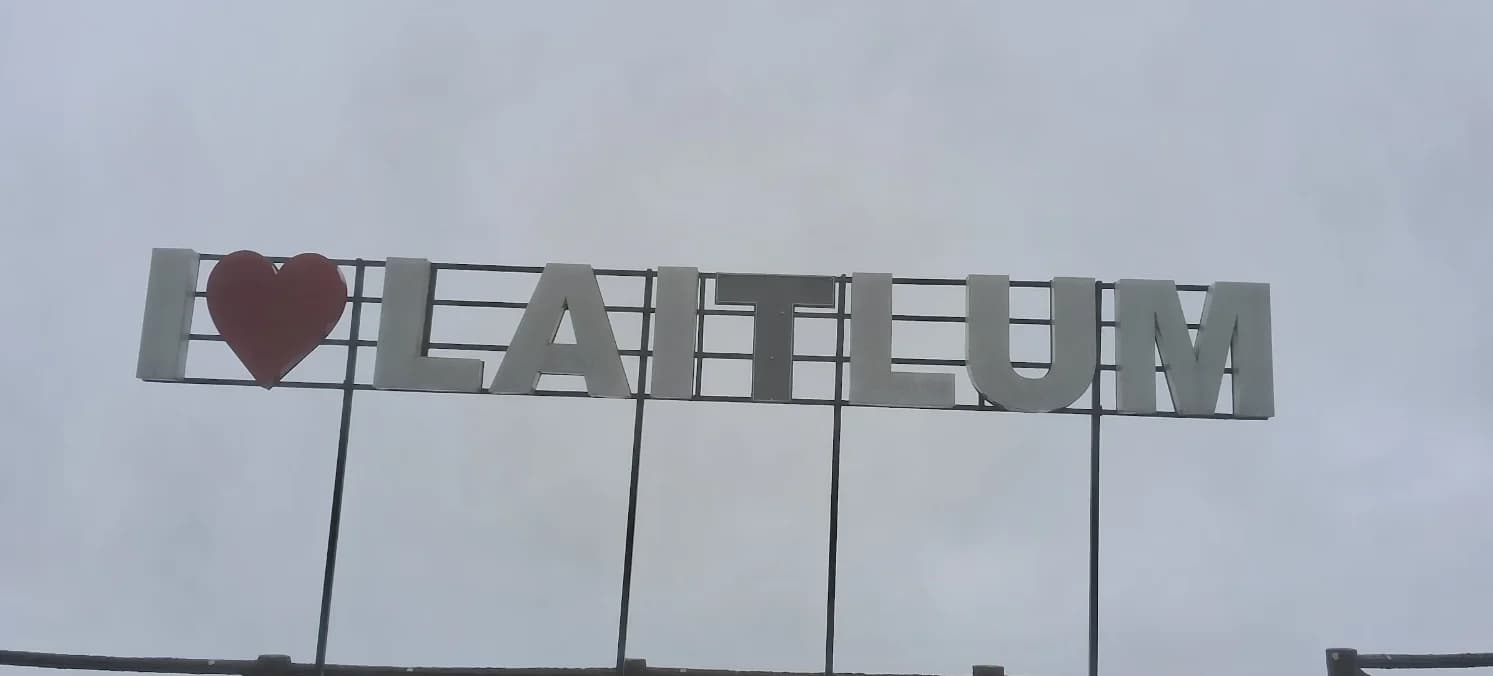 The I love Laitlum sign silhouetted against an overcast sky